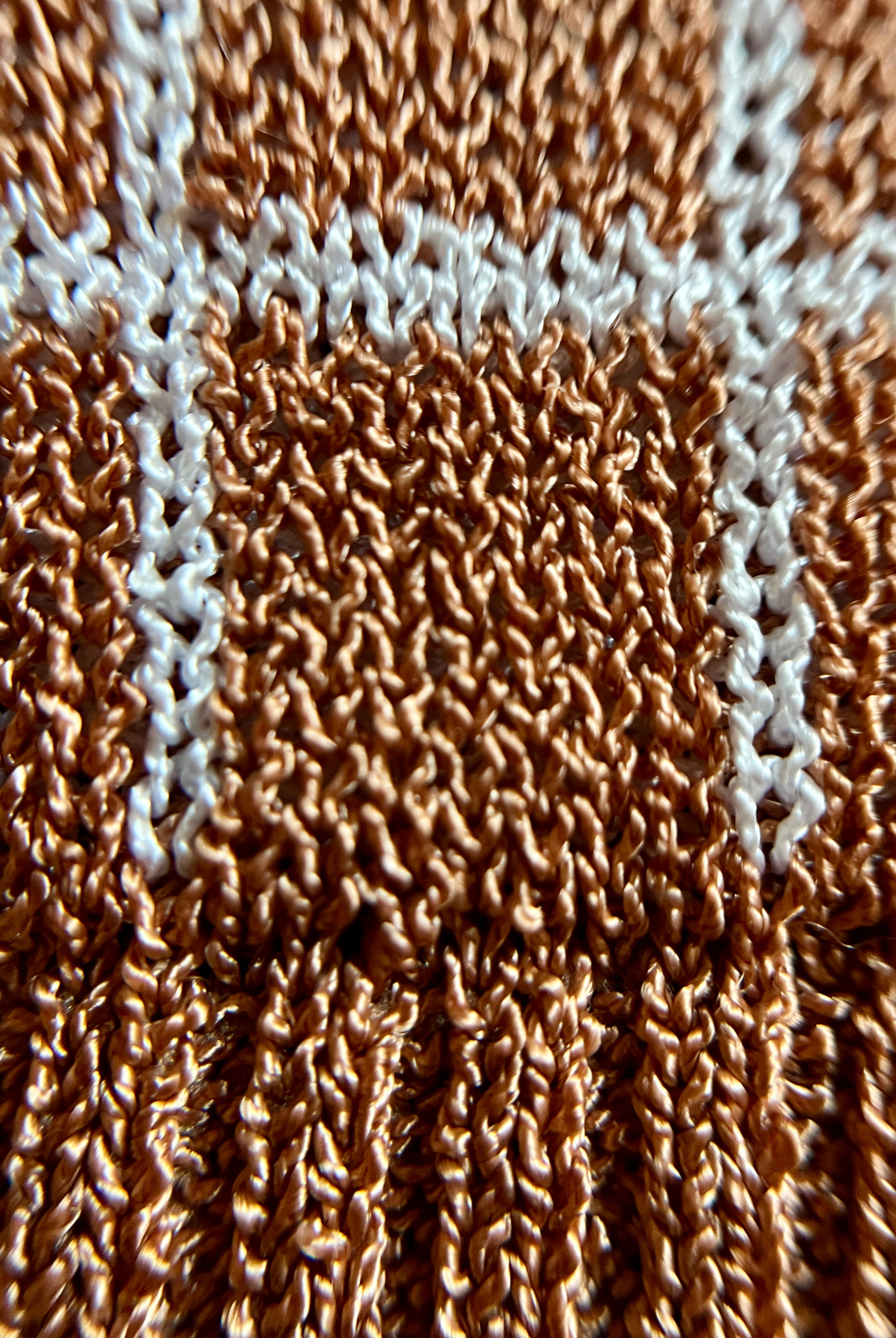 Combelle Madison Top in tobacco, extreme macro detail of the two-tone viscose check yarn showing the warm tobacco and stone construction and fabric texture