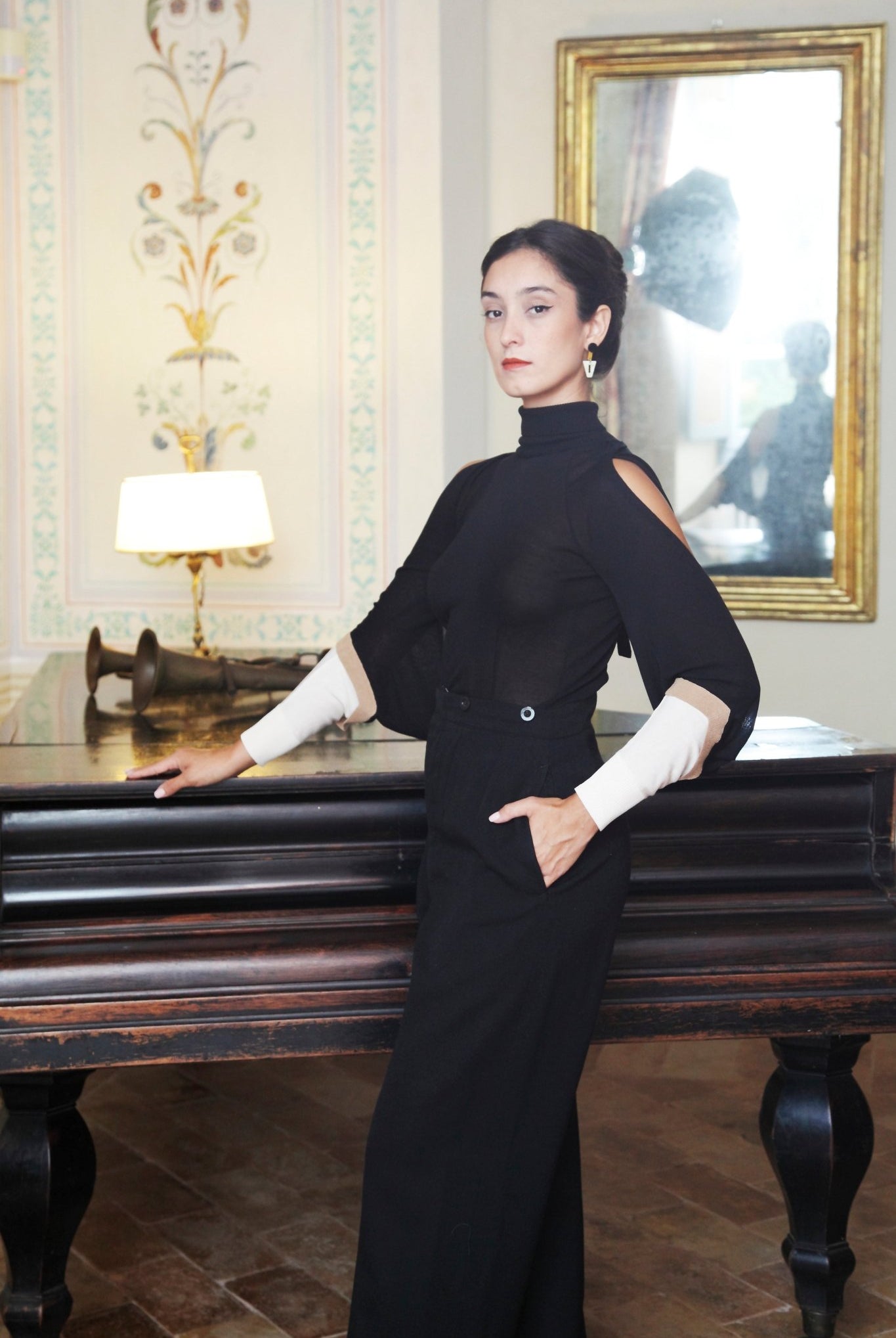 Combelle Elsa Top in black styled with tailored trousers, three-quarter front view in an elegant interior setting