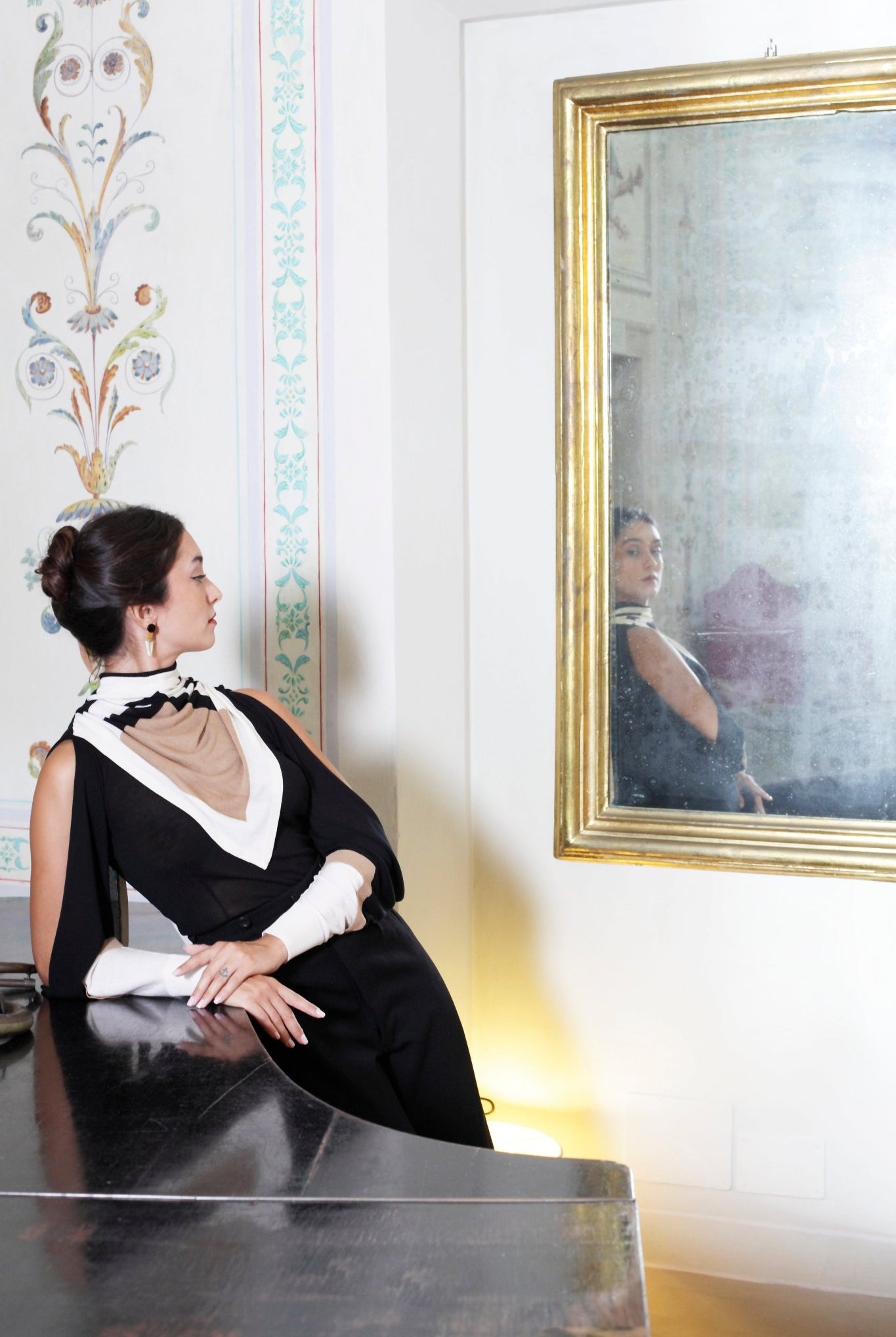 Combelle Elsa Top in black with Frida Foulard, front view against grand piano showing the bold graphic contrast of the combined styling
