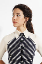 Combelle Colbert Dress front view with model in side profile, showing diagonal stripe pattern across the bodice