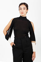 Combelle Elsa Top in black, full length front view showing the open sleeve construction and high neck against a white background
