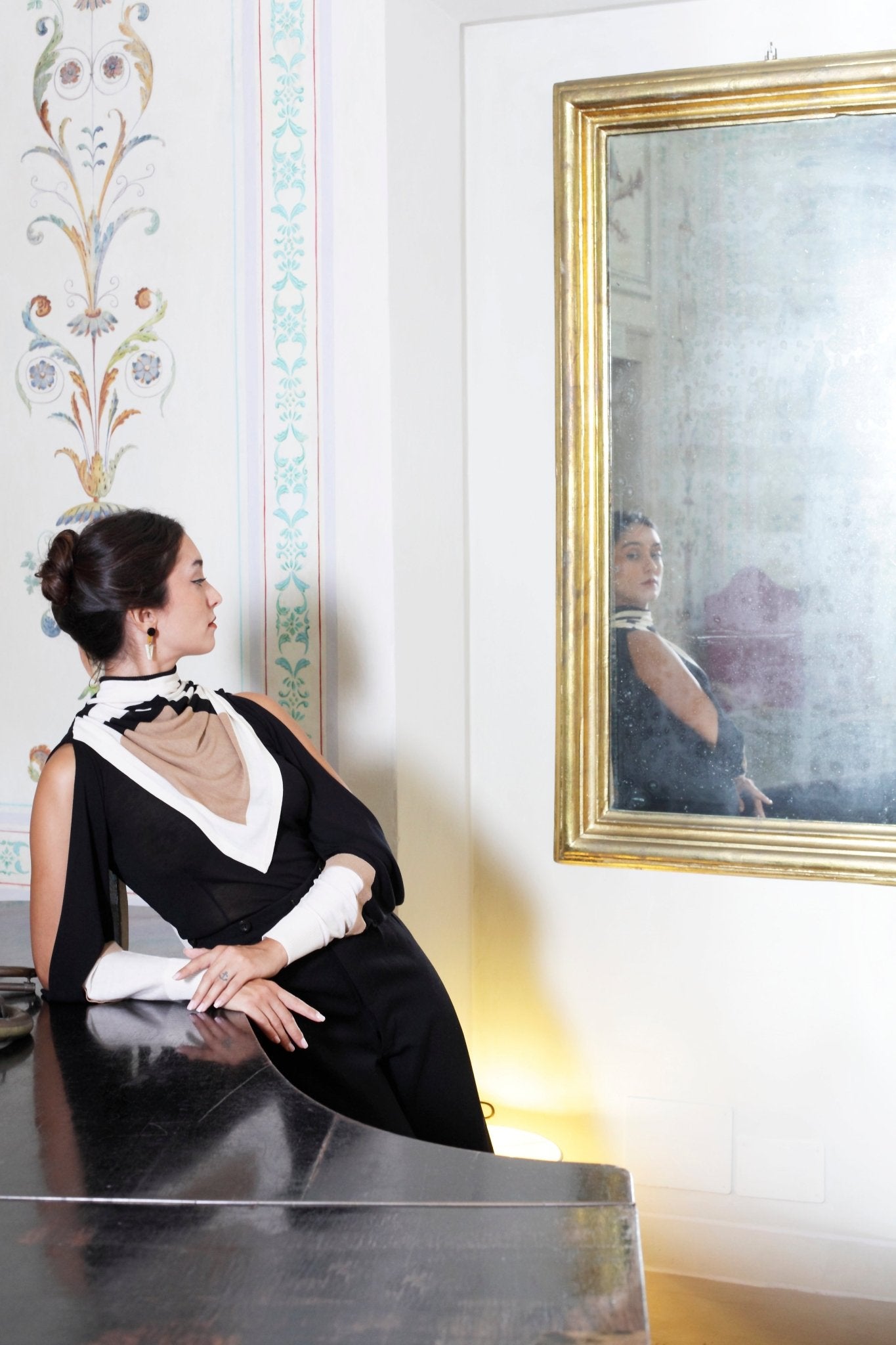 Combelle Elsa Top in black with Frida Foulard, front view against grand piano showing the bold graphic contrast of the combined styling