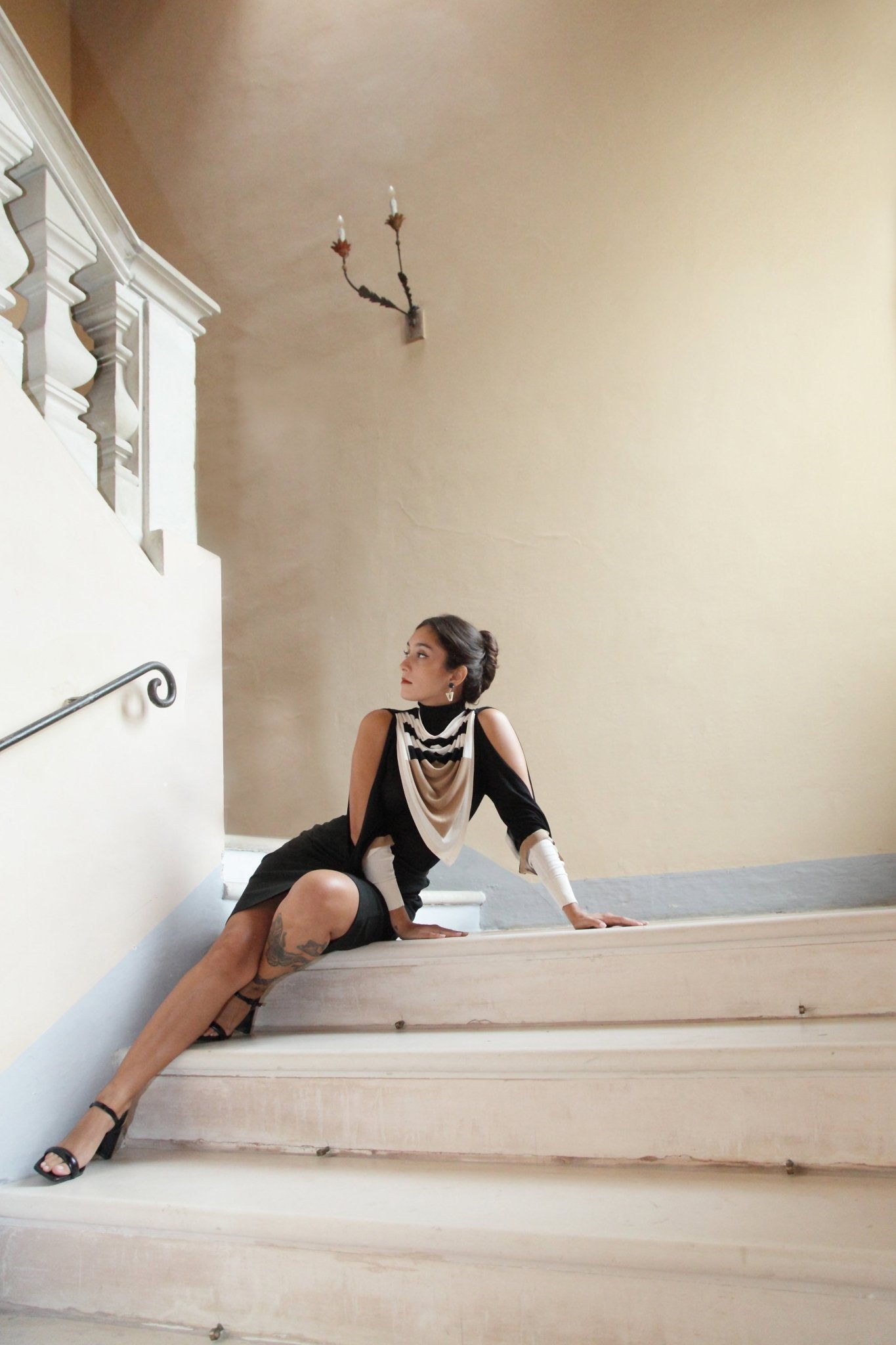 Combelle Elsa Top in black with Frida Foulard, full length body on staircase highlighting the exposed shoulders and foulard drape