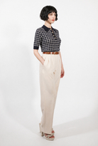 Combelle Madison Top in navy, full length three-quarter view showing the complete silhouette and two-tone check against cream wide-leg trousers