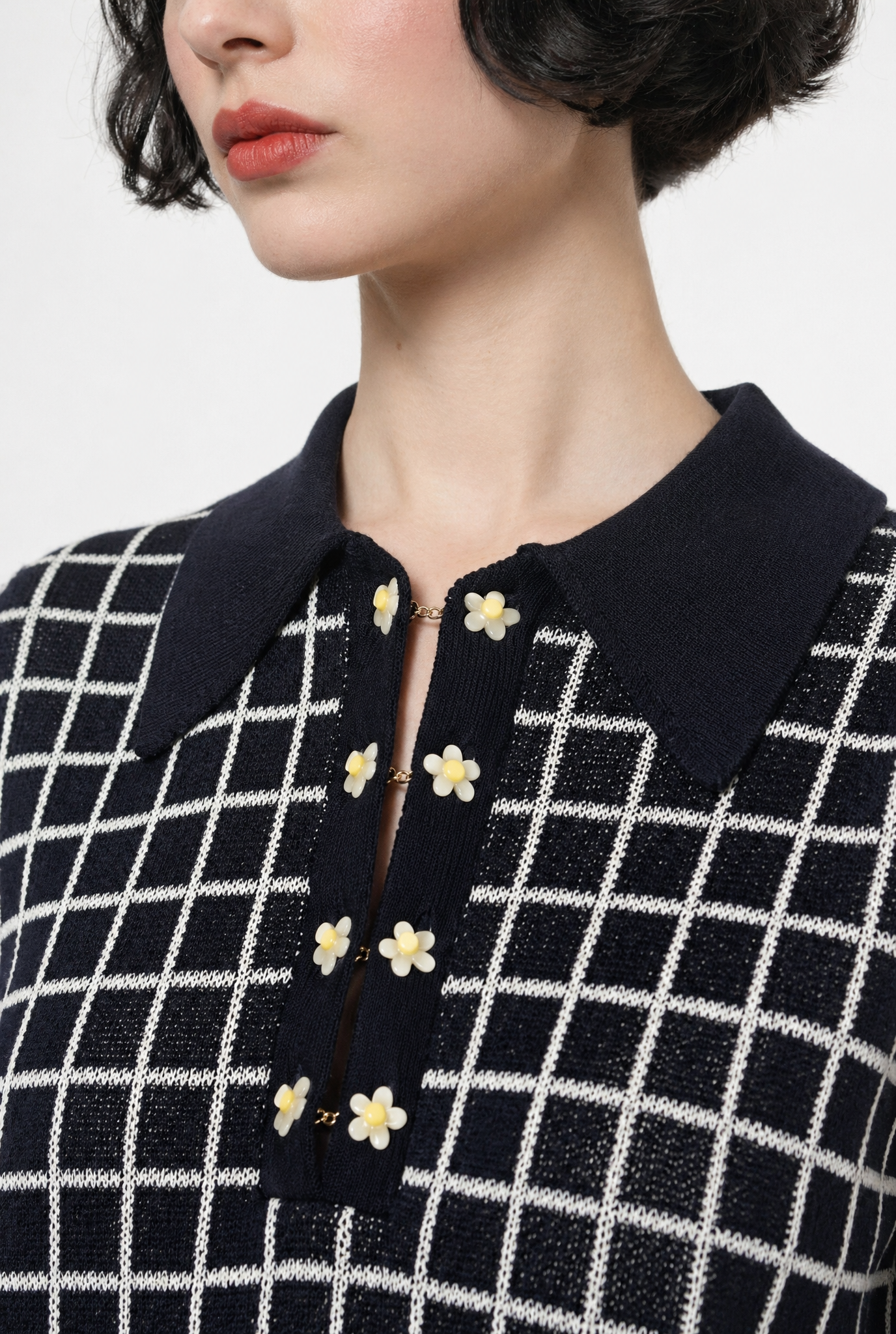 Combelle Madison Top in navy, upper body close-up showing the polo collar and daisy chain cufflink buttons against the two-tone check