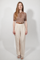 Combelle Madison Top in tobacco, full length straight front view showing the complete silhouette and daisy chain buttons against cream wide-leg trousers