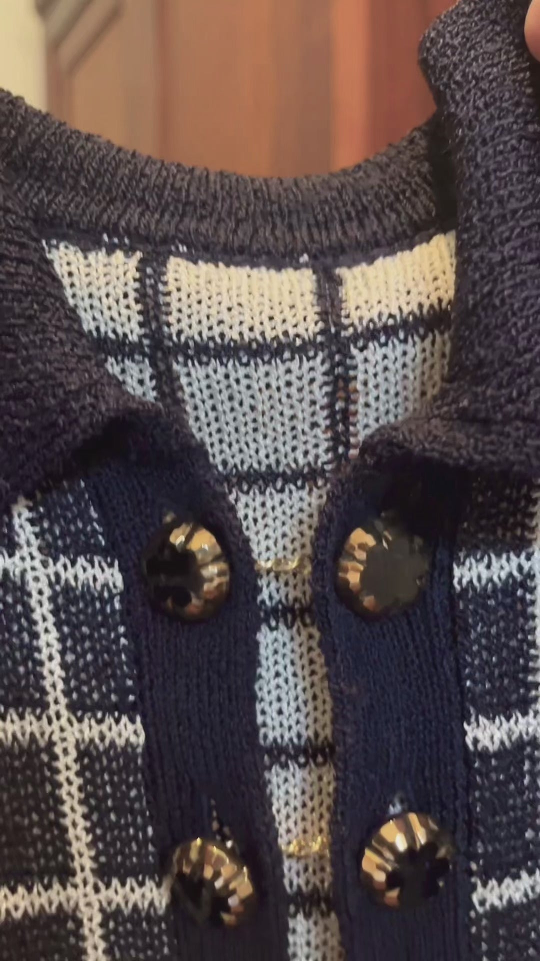 Combelle Madison Top navy close-up video with hand-painted glass evening buttons, showing the fabric drape, surface texture and artisan button quality